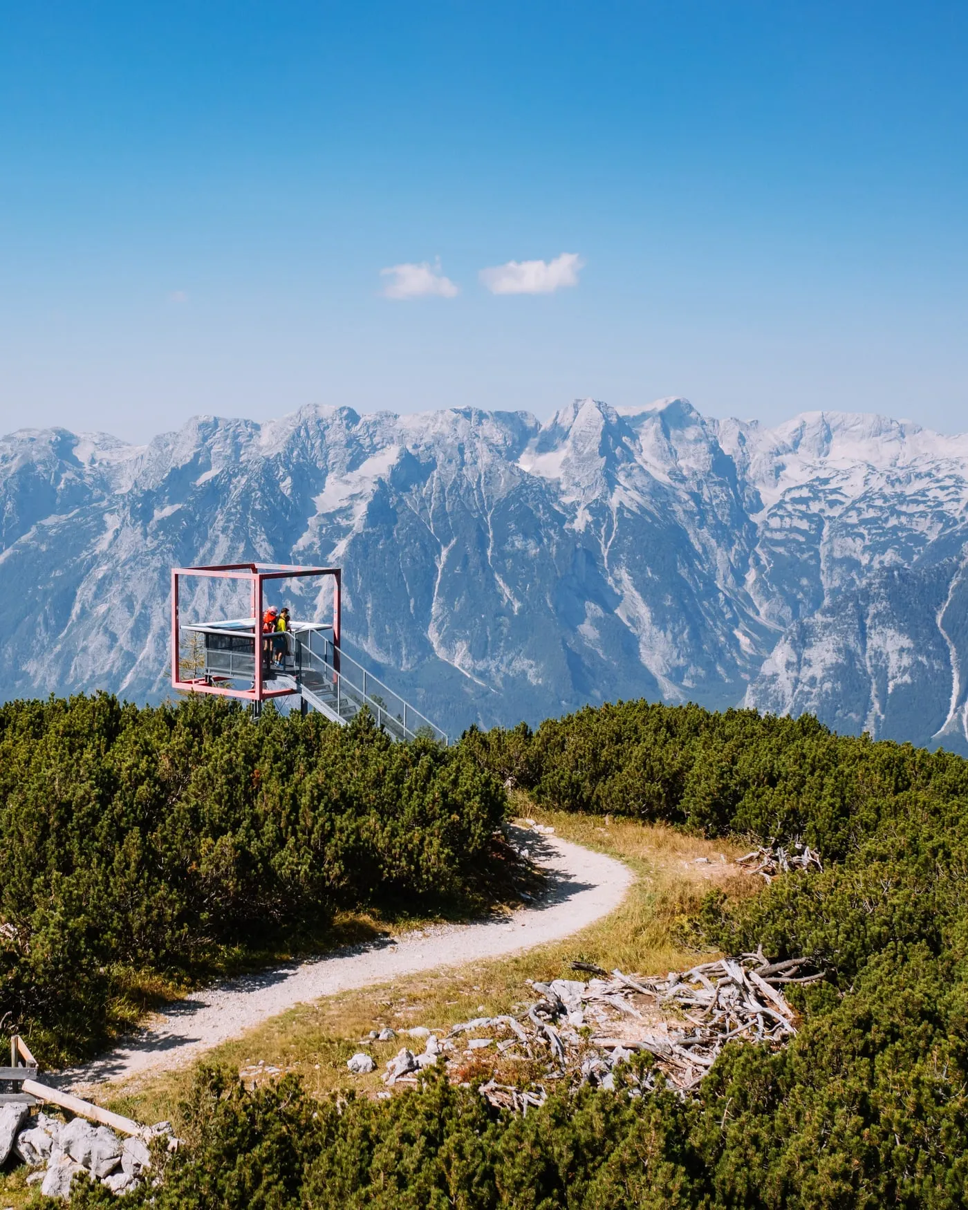 Hiking path across the alpine meadows of the Hutterer Höss with a view of the Totes Gebirge